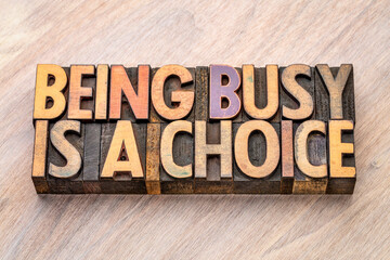 being busy is a choice - word abstract in vintage wood type, business and lifestyle concept