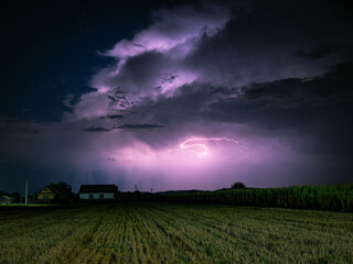 Fototapeta premium Majestic Cumulonimbus storm cloud is lit by lightning at night
