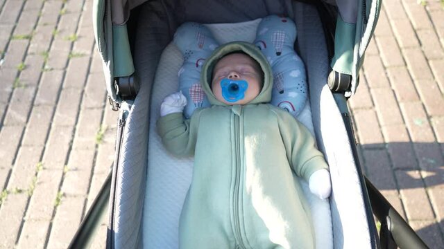 Baby lying in the pram on walk