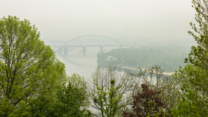 View through the fog, from Vladimirskaya Gorka to the pedestrian bridge over the Dnieper in Kiev.