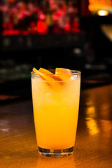 Peach fizz cocktail at the bar on wooden background