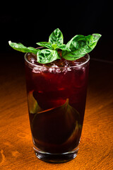 Fresh homemade cherry lemonade on dark bar background. Summer refreshment drink close up.