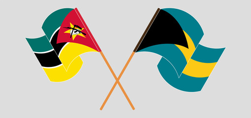 Crossed and waving flags of Mozambique and the Bahamas