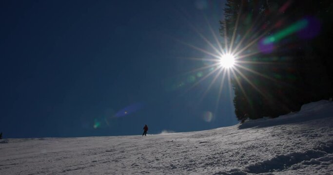 Panning Shot Of Tourist Skiing Over Snowy Mountain Against Clear Sky During Vacation On Sunny Day - Vail, Colorado