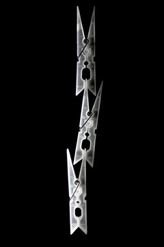 Clothes pegs to form a tower on black background