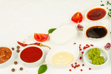 Set of different sauces - ketchup, mayonnaise, barbecue, soy, chutney, wasabi, adjika, horseradish
