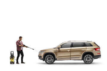 Full length shot of a man cleaning a suv with a pressure washer machine