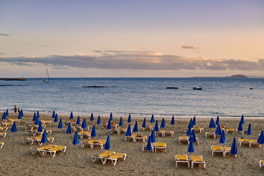 Loungers and umbrella near sea