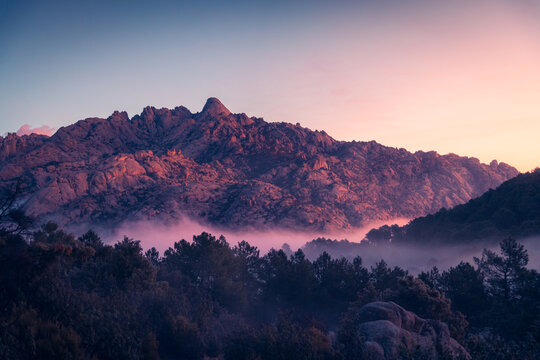 Fog between ridges and boulders at dawn