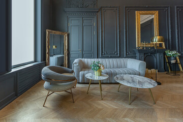 chic interior of the room in the Renaissance style of the 19th century with modern luxury furniture. walls of noble dark color are decorated with stucco and gilded frames, wooden parquet.