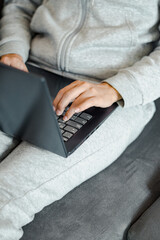 woman's hands working with her laptop comfortably at home
