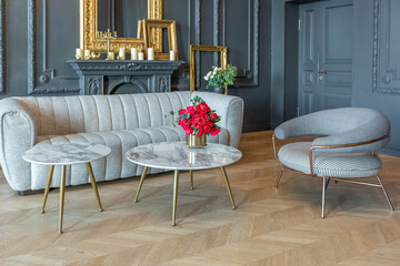 chic interior of the room in the Renaissance style of the 19th century with modern luxury furniture. walls of noble dark color are decorated with stucco and gilded frames, wooden parquet.