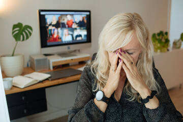 Fatigue woman from work at home. Tired businesswoman sleeping on his work desk while having a video...