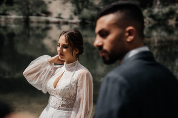 selective focus. gentle and loving newlyweds on the shore of a mountain lake.