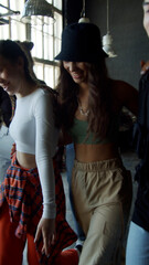 Group of dancers came to a rehearsal in a fashionable studio in dark colors