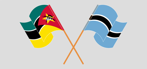 Crossed and waving flags of Mozambique and Botswana