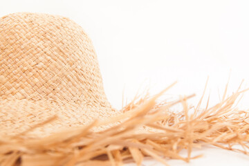 Beautiful straw hat with with ragged edges on white background, style and fashion