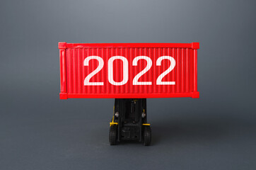 Forklift holds a container with 2022. Analytics forecasting of freight traffic next year. Express...
