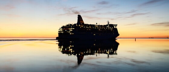 Large white cruise liner (passenger ship) sailing in the Baltic sea at sunset. Finland, Aland....