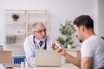 Young male asthamatic visiting old male doctor