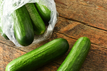 A top view image of organically grown cucumbers on an old rustic table top. 