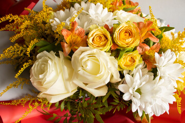 autumn bouquet of flowers from roses, mimosa. Growing flowers, flower business, floristry