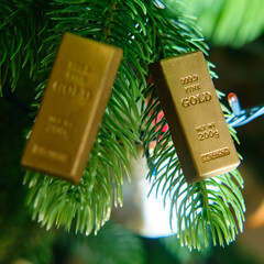 Gold bars on the branch of the Christmas tree on New Year Eve