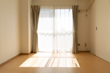 sunlight coming inside empty room with white wall and wooden bwon floor in tokyo, japan