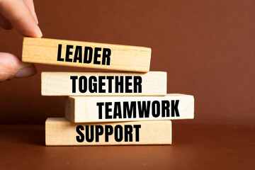 Leader, Together, Teamwork and Support blocks on table background. Business, corporate and success concept