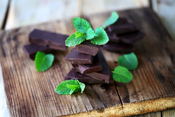 Mint chocolate. Dark chocolate with fresh mint leaves. Organic food.