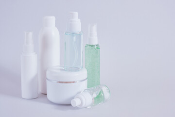 Composition of different cosmetic bottles mock-up on gray background