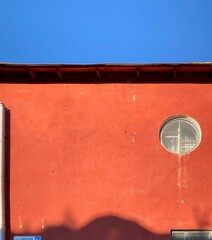 red wall and blue sky