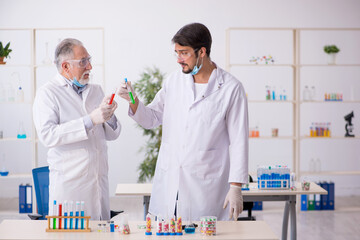 Two male chemists in drugs synthesis concept at the lab