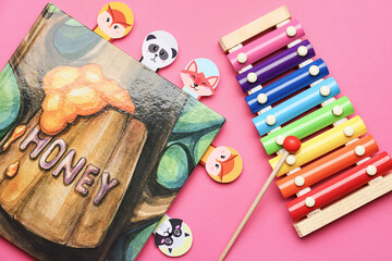 Cute bookmarks with book and xylophone on color background