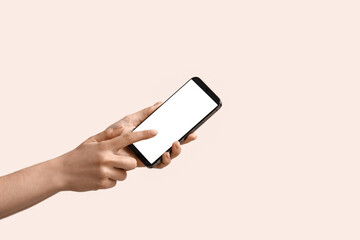 Woman using mobile phone on color background