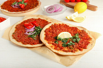 Delicious Turkish pizza on white wooden background