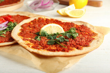 Delicious Turkish pizza on white wooden background