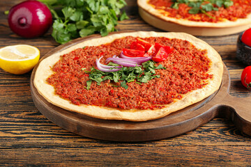 Board with delicious Turkish pizza on wooden background