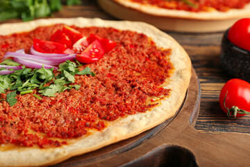 Board with delicious Turkish pizza on wooden background