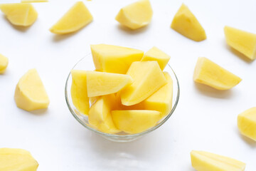 Cut peeled potatoes on white background.