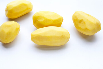 Raw peeled potatoes on white background