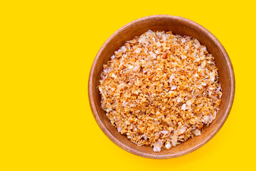 Fried chopped garlic on yellow background.