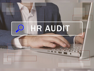  HR AUDIT Human resources phrase on the screen. Modern Banker use internet technologies at office....