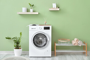 Interior of bathroom with modern washing machine