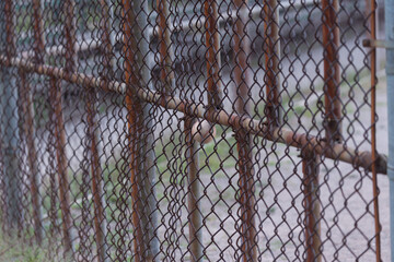 rusty metal fence with softball