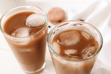 Glasses of tasty iced coffee on table, closeup