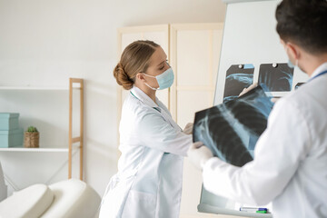 Young doctors with x-ray scan in clinic