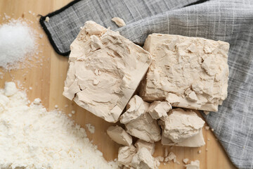 Fresh yeast and flour on wooden background