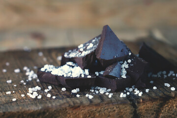 Pieces of dark chocolate with sea salt. Salted dark chocolate.