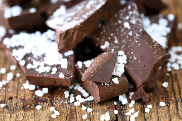 Pieces of dark chocolate with sea salt. Salted dark chocolate.